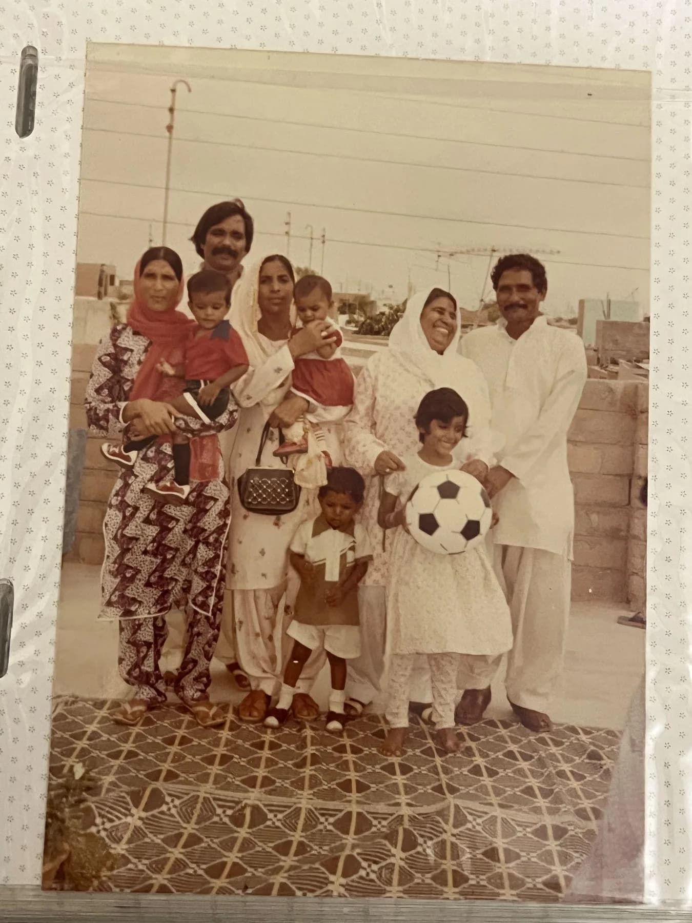 Extended family gathered on a Qayyumabad rooftop